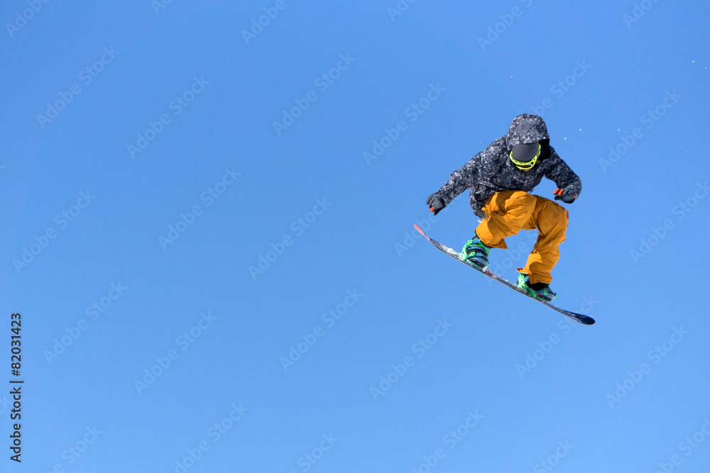 Snowboarder jumps in Snow Park Snowboarder jumps in Snow Park