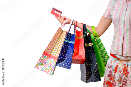 Woman holding shopping bags and credit card isolated on white