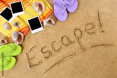 Escape word text message written in sand on a tropical beach with seashells and accessories polaroid style photo frame print summer holiday vacation photo