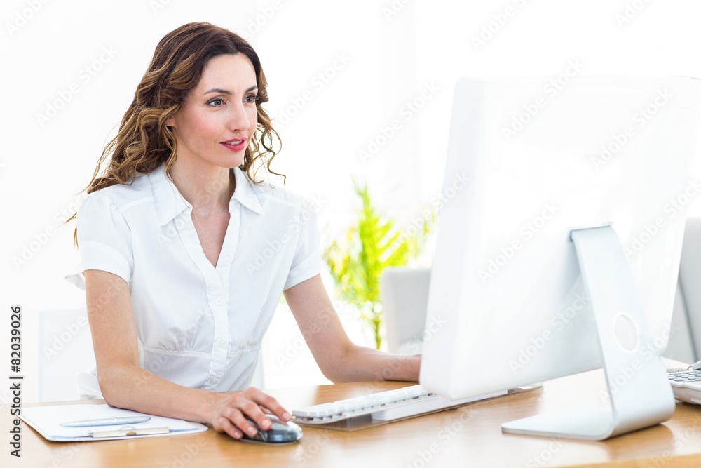 Smiling businesswoman working with computer