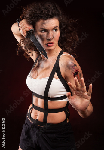 Wallpaper Mural Portrait image of an abused woman holding a sharp knife Torontodigital.ca