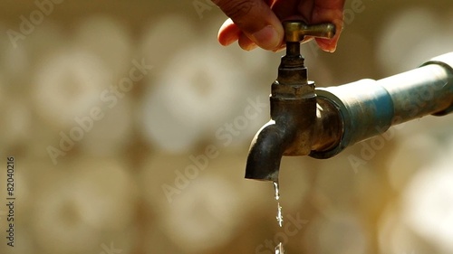 human is turning off the tap water