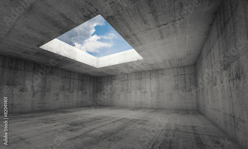 Empty dark concrete room interior with window in ceiling