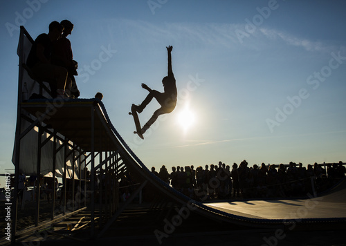 Skateboarder jumping on a ramp
