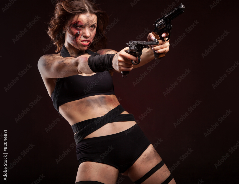 Woman warrior posing with knife. Ready to fight. With dirty face Woman warrior posing with knife. Ready to fight. With dirty face