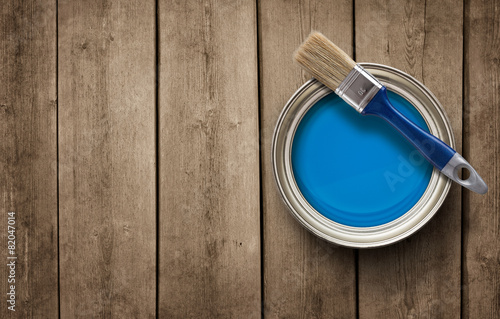 Paint can on the old wooden background with copy space