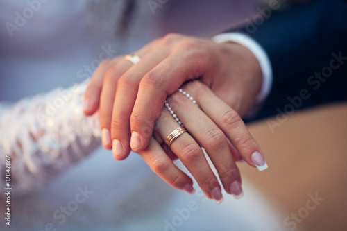 Wedding theme, man and woman holding hands with nice manicure.