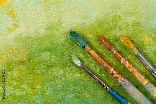 Artists vintage tools brushes on green artistic background