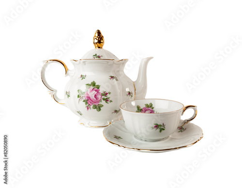 Porcelain teapot, teacup and saucer with rose