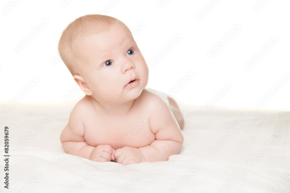 Little boy lying on stomach and looking aside Little boy lying on stomach and looking aside