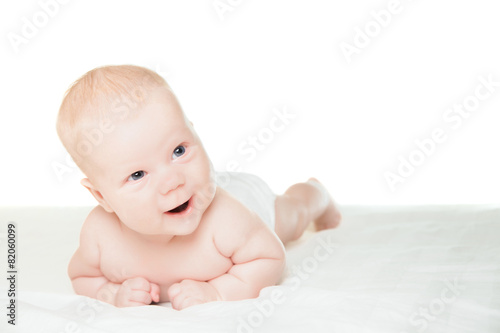 Little boy lying on stomach and smiling