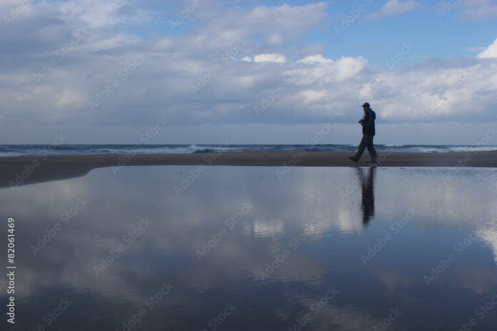 man Silhouette walking on a beach