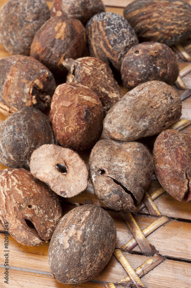 shea nuts near butter on white background shea nuts near butter on white background
