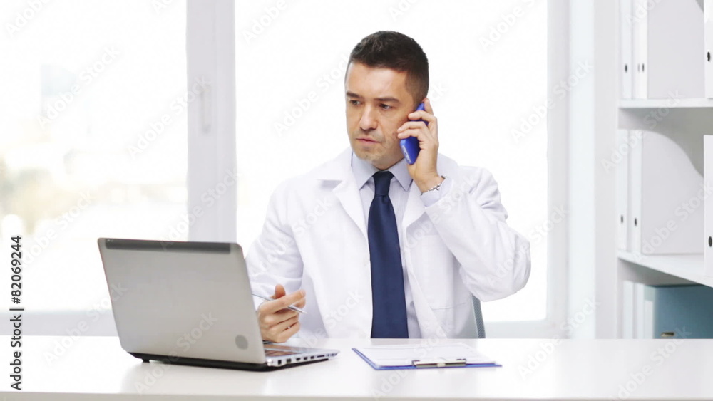 doctor with laptop calling on smartphone doctor with laptop calling on smartphone