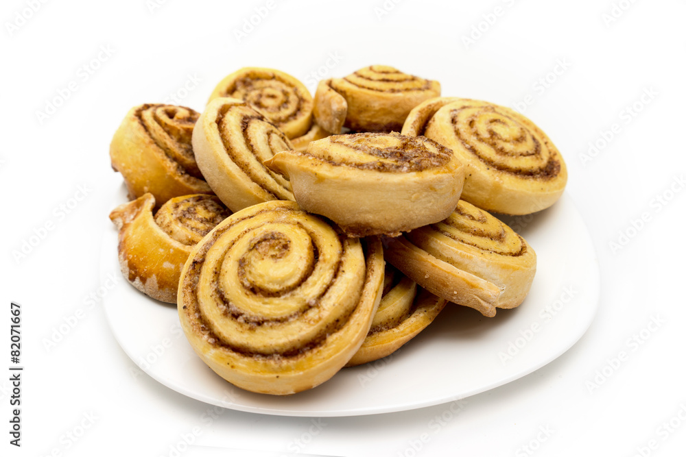 Tasty homemade fresh cinnamon rolls on a plate isolated Tasty homemade fresh cinnamon rolls on a plate isolated