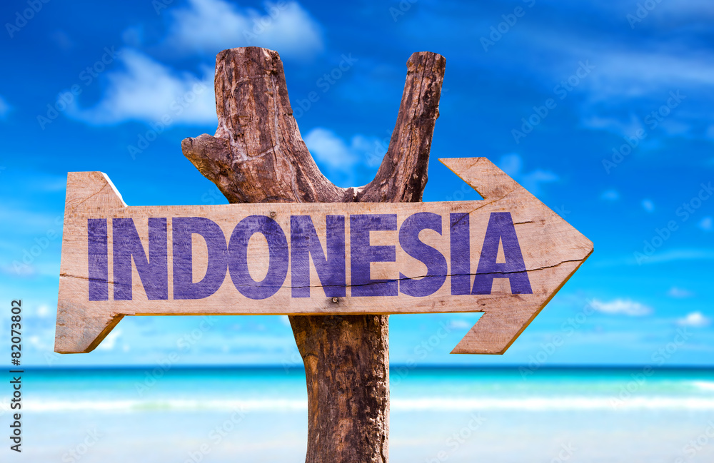 Indonesia wooden sign with beach background