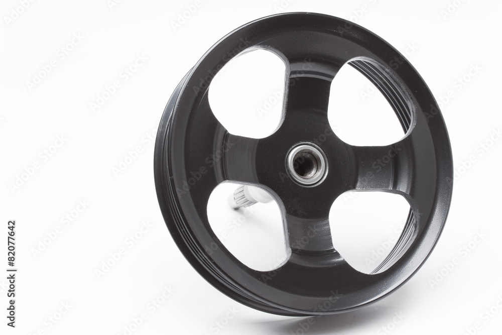 Obraz premium Black pulley car engine on a gray background