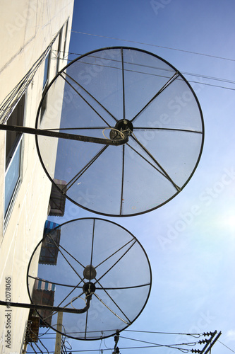 Satellite dish on blue sky.