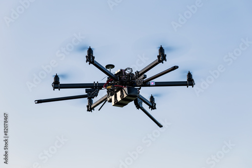 Fototapeta Naklejka Na Ścianę i Meble -  Professional drone hexacopter flying on blue sky