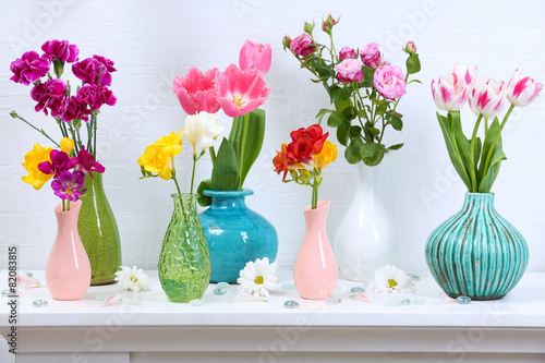 Fototapeta Naklejka Na Ścianę i Meble -  Beautiful composition with different flowers in vases