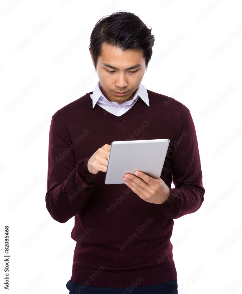 Asian businessman look at digital tablet Asian businessman look at digital tablet