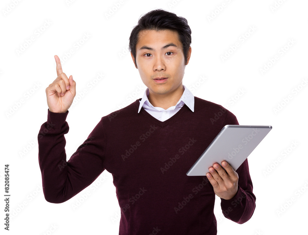 Asian businessman look at digital tablet and finger point up Asian businessman look at digital tablet and finger point up