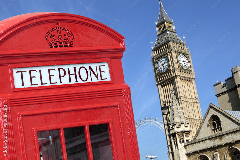 Obraz premium London red telephone box booth with westminster british houses of parliament building and Big Ben clock tower in the background photo