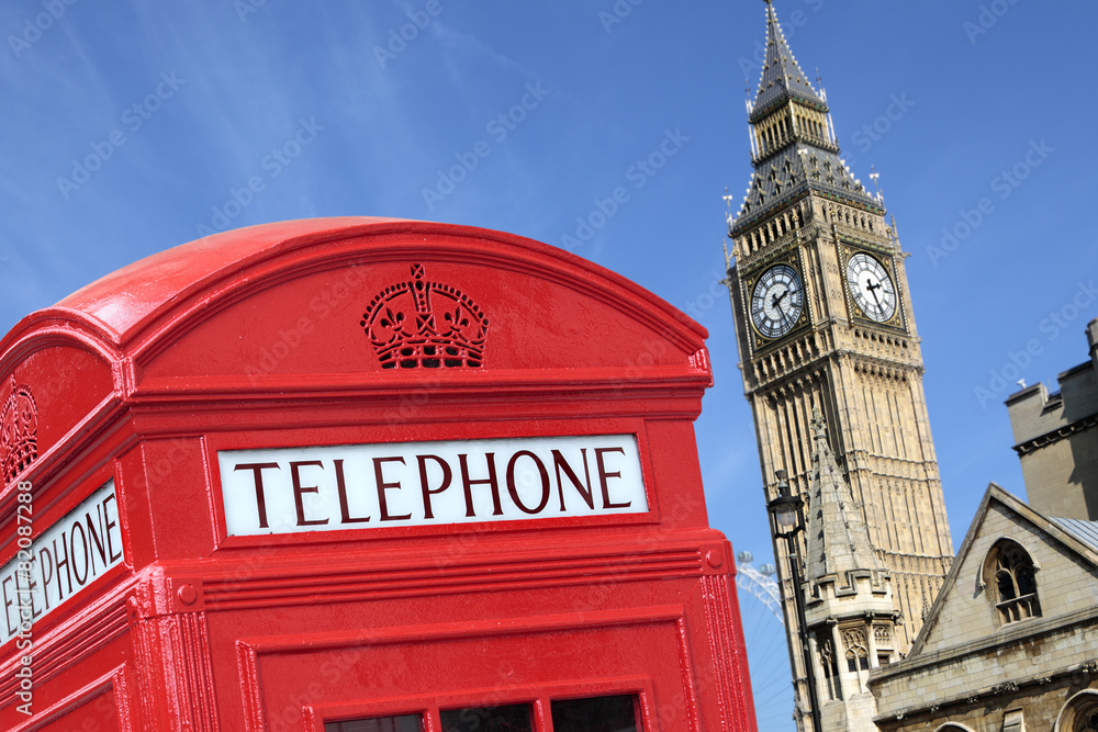 Obraz premium London red telephone box booth with westminster british houses of parliament building and Big Ben clock tower in the background photo