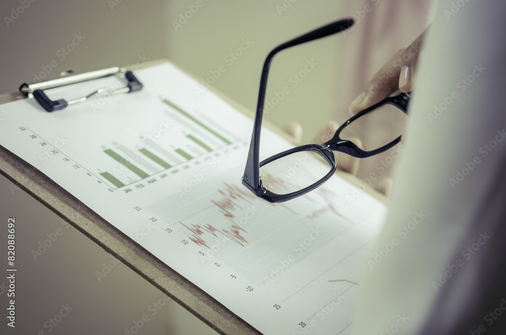hands holding binder while reading the graphs hands holding binder while reading the graphs