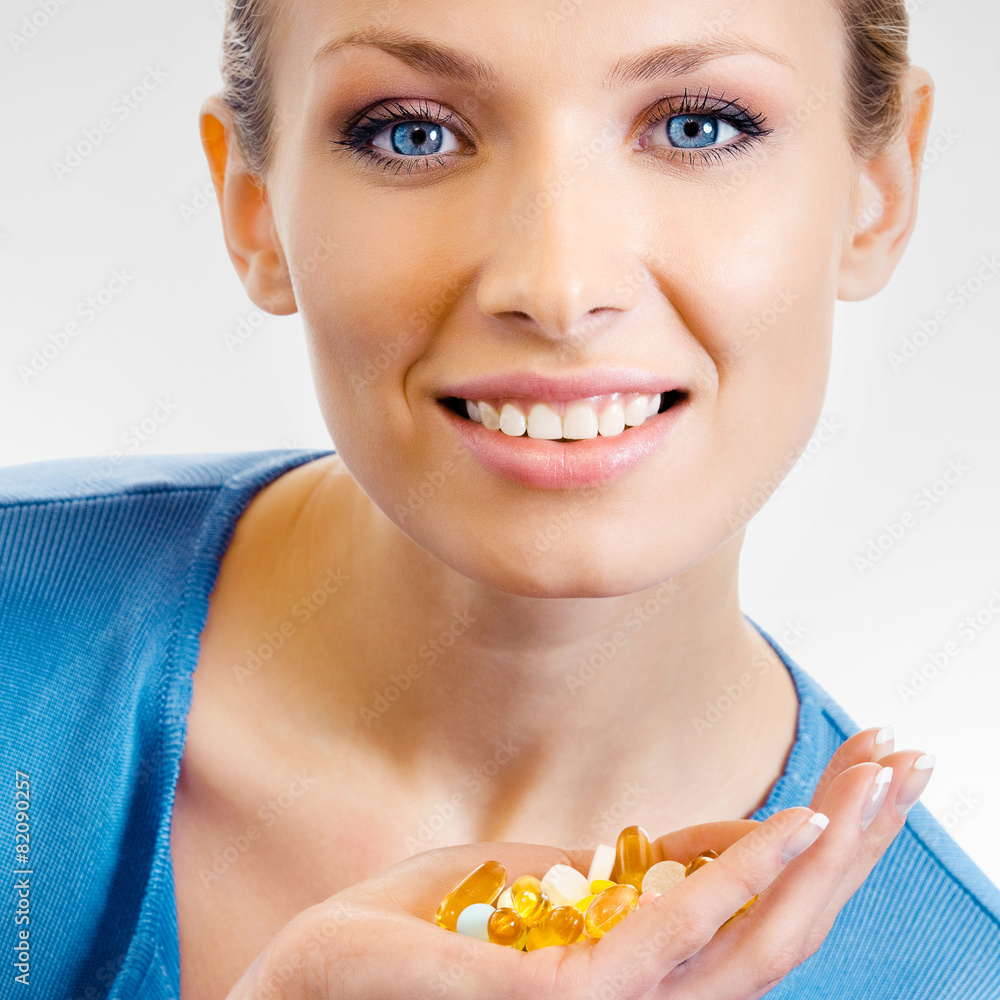 Woman with assorted pills and capsules Woman with assorted pills and capsules