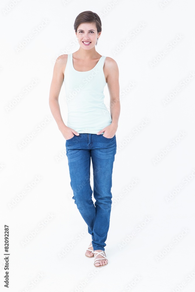 Pretty brunette smiling at camera with hands on pocket Pretty brunette smiling at camera with hands on pocket