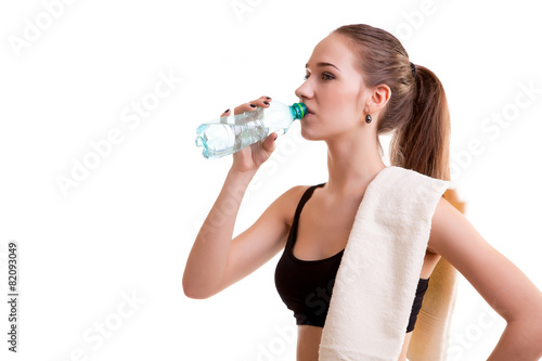 Woman after sport drinking water from bottle