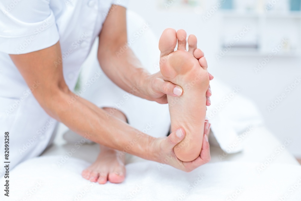 Physiotherapist doing foot massage Physiotherapist doing foot massage