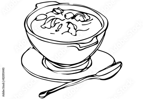 bowl of soup with herbs and spoon lying next