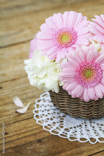 Bouquet of pink gerberas on wooden table