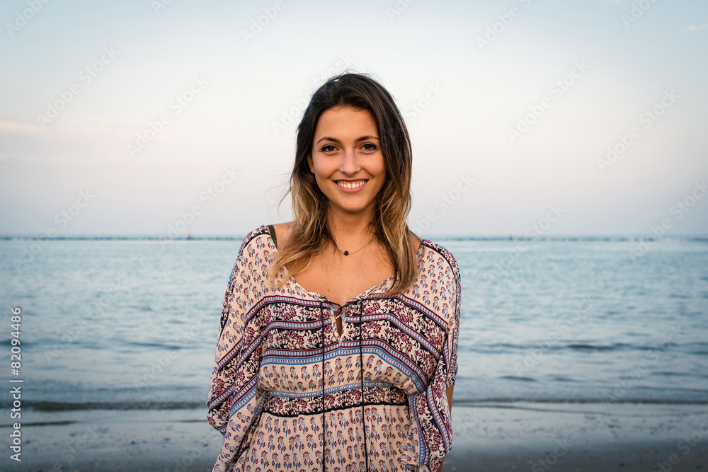 Beautiful young woman smiling portrait at the beach with sea in Beautiful young woman smiling portrait at the beach with sea in