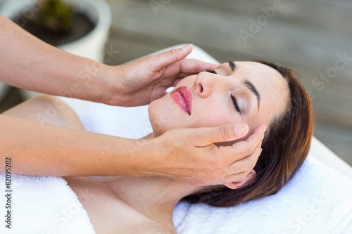 Brunette receiving head massage