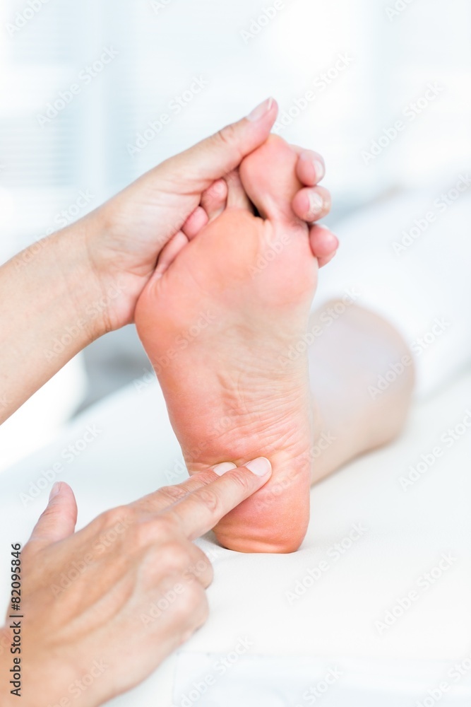 Fototapeta premium Physiotherapist massaging her patients foot