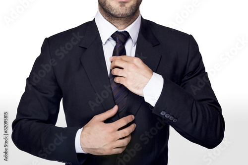 Businessman adjusting a tie