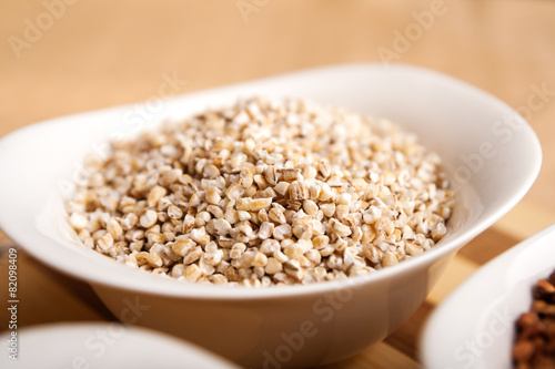 Barley groats in white bowl
