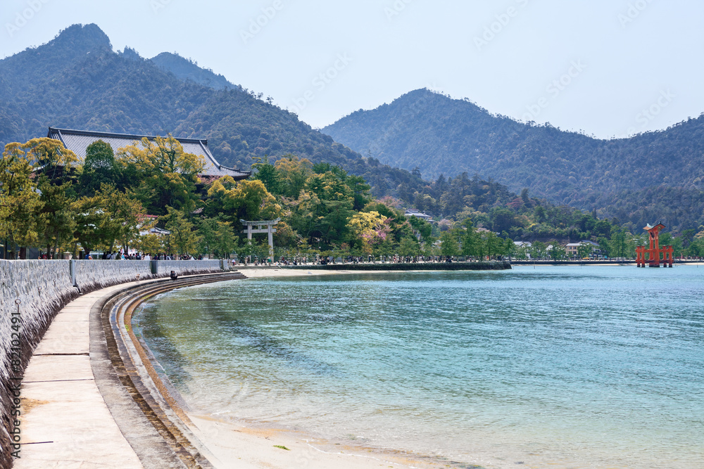 Sea coast on island of Miyajima (Itsukushima), Japan. Red torii