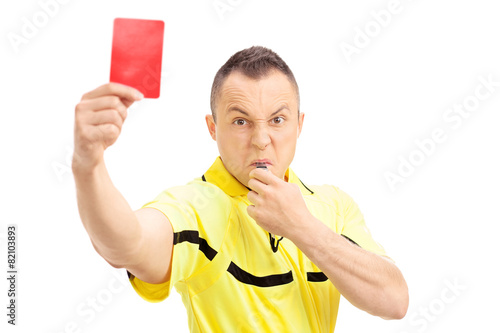 Foto Furious football referee showing a red card