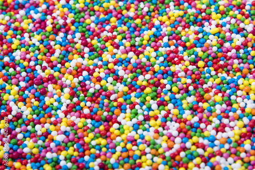 Mix of colorful Sugar balls powder background