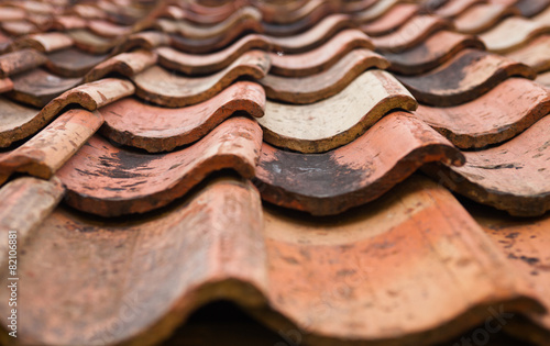 The old roof covered with orange tiles