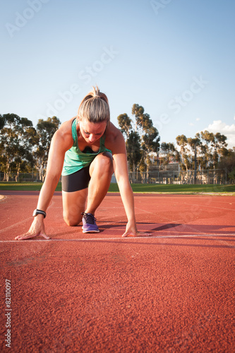 Female runner on an athletics track