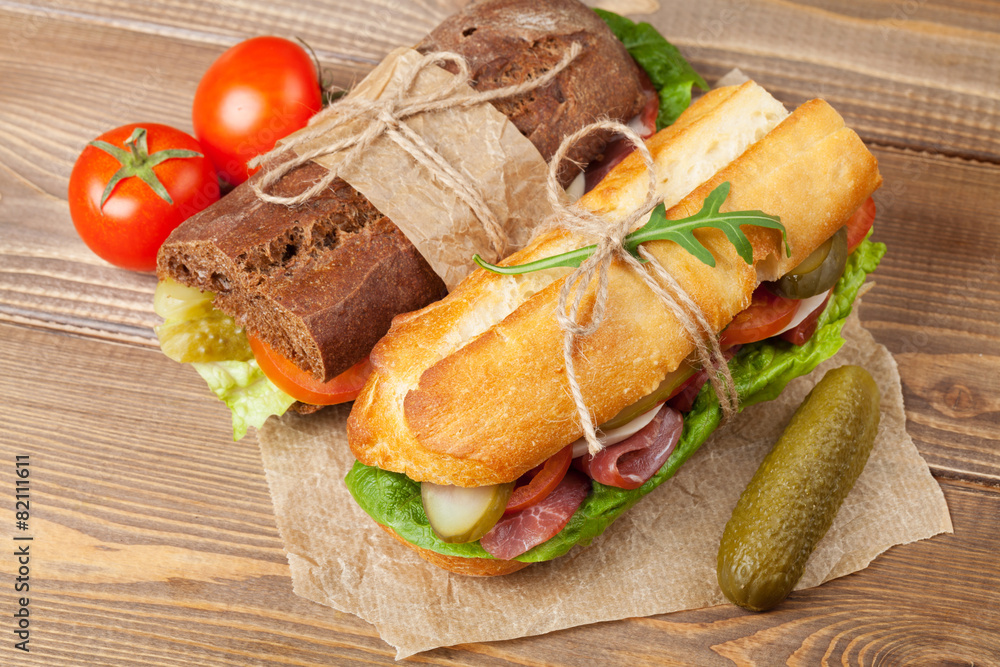 Two sandwiches with salad, ham, cheese Two sandwiches with salad, ham, cheese