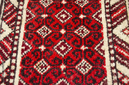 Wool rug with red background