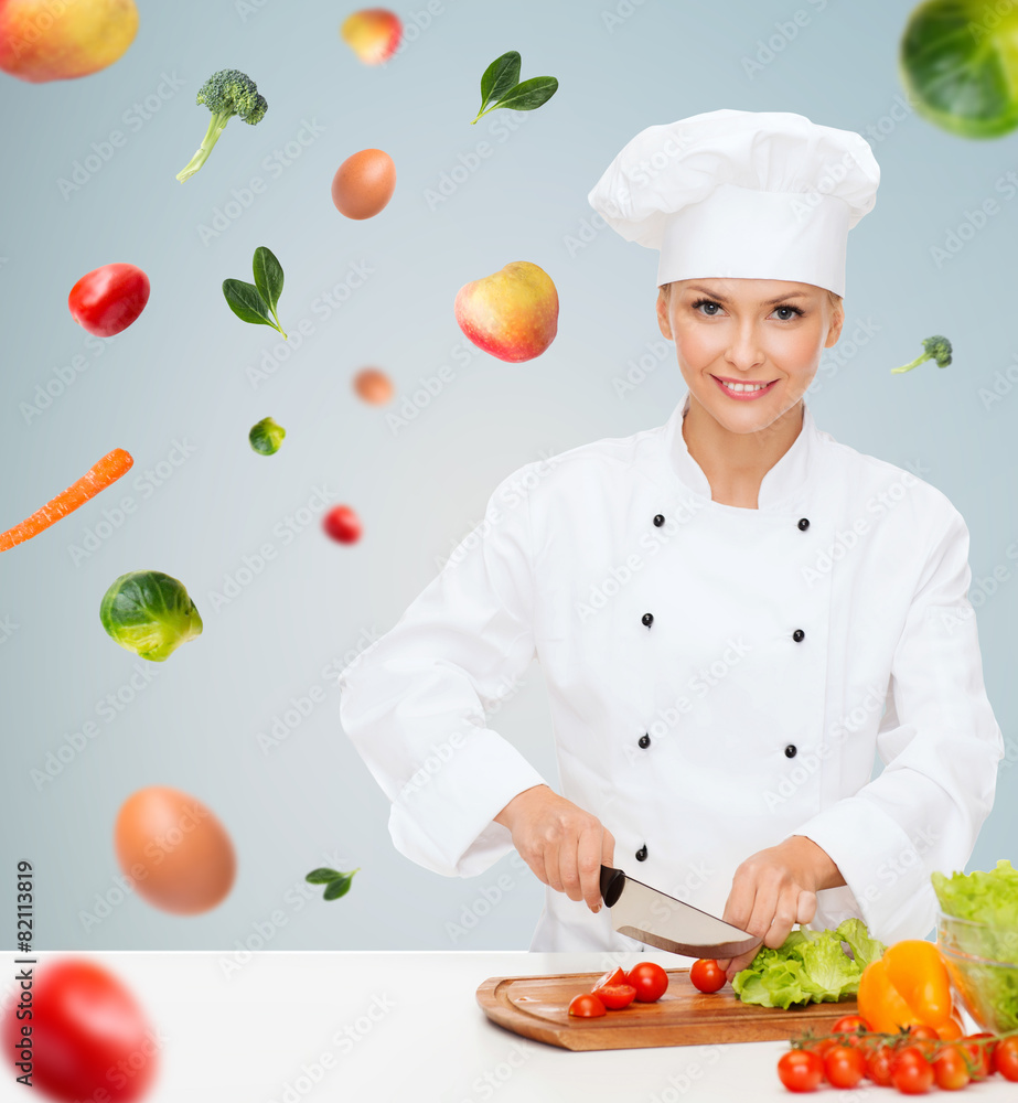 smiling female chef chopping vegetables smiling female chef chopping vegetables
