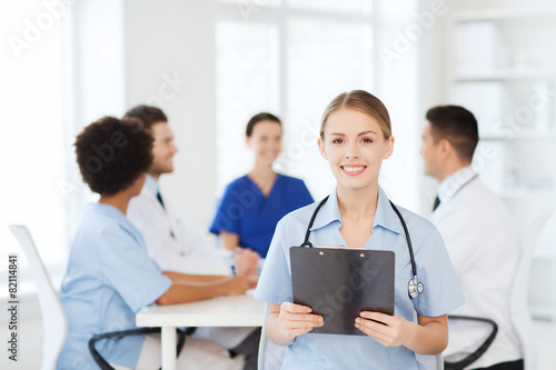 happy doctor over group of medics at hospital