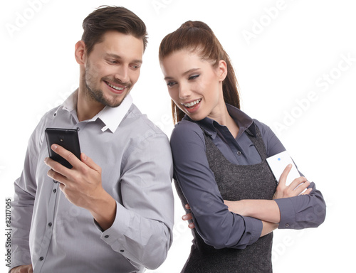 Attractive couple taking a selfie together on white background